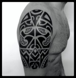 maori style half arm tattoo