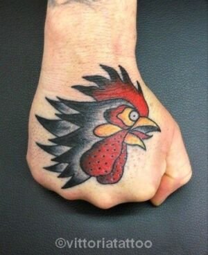 rooster head on hand