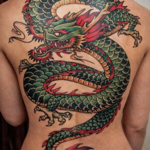 Japanese dragon back tattoo covering the entire back, traditional style, done at Vittoria Tattoo Shop in Aubusson.