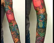 Tatouage manchette couleur style cartoon avec Stitch et personnages inspirés de l’univers Disney, réalisé sur le bras , salon de tatouage vittoriatattoo shop à Aubusson.